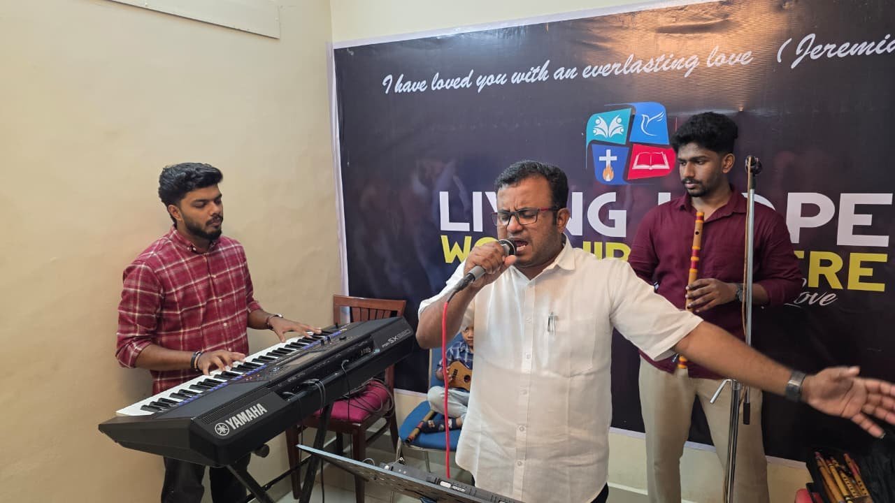 Stanley Abraham leading worship with keys and flute at Living Hope Worship Center