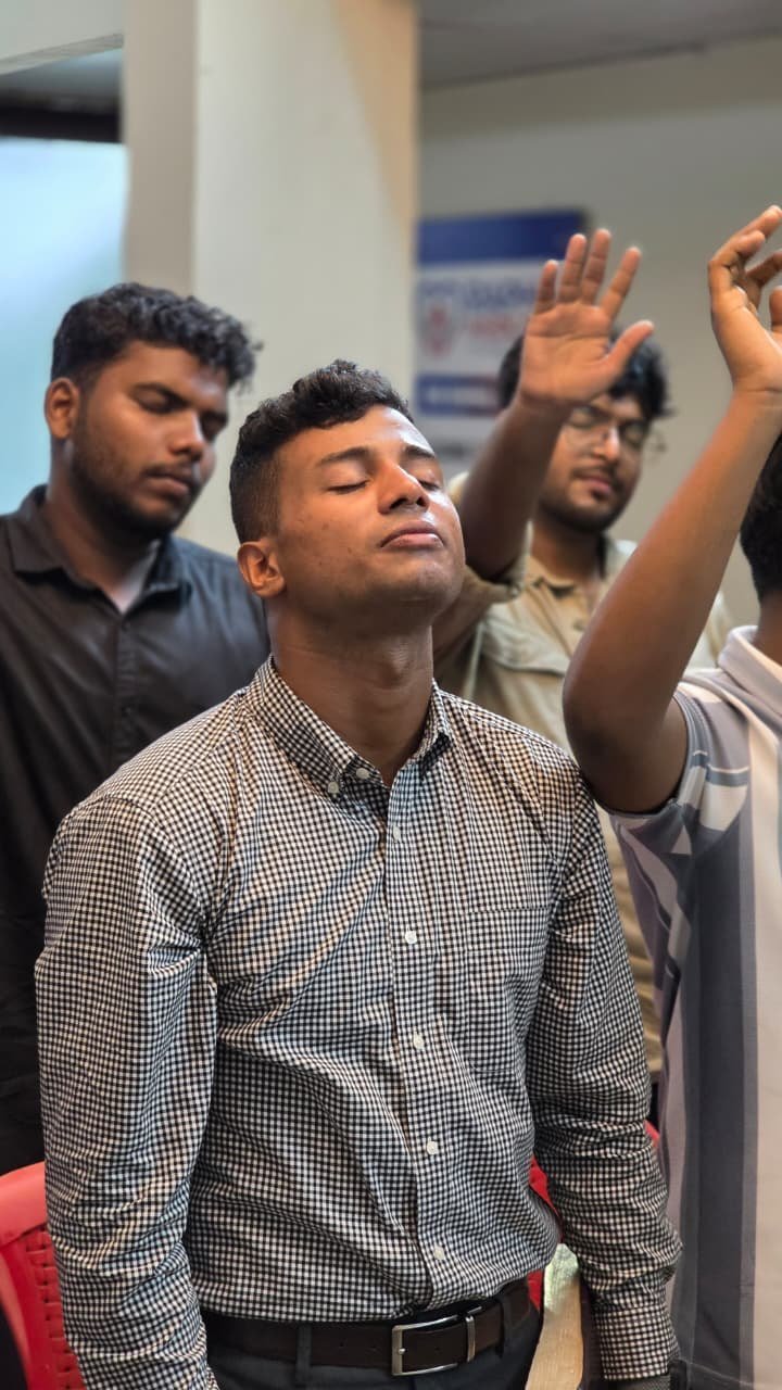 Young people worshipping with raised hands at Living Hope